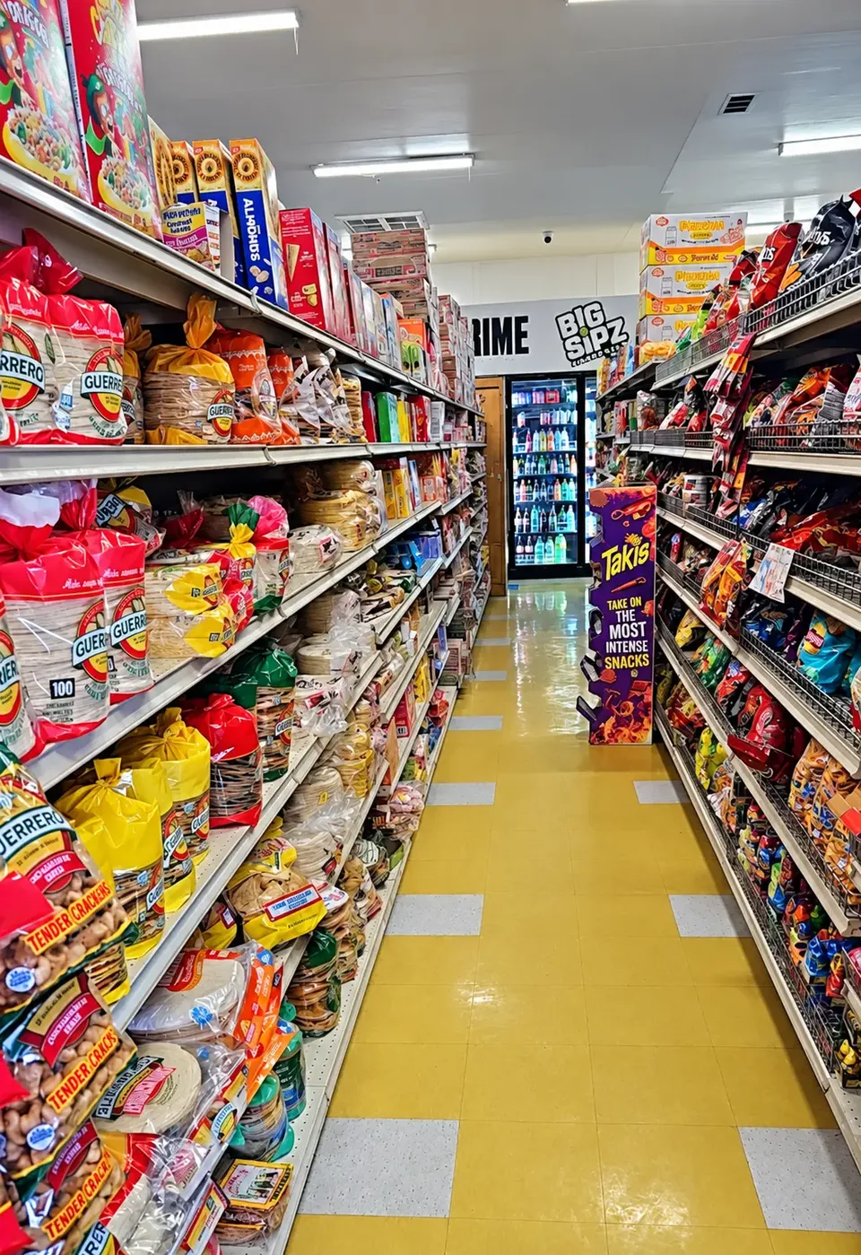 Grocery aisle stocked with tortillas, chips and packaged snacks